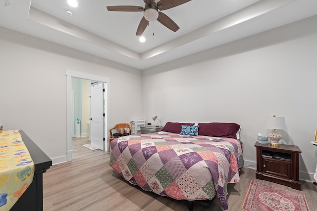 165 Hunters Chase Ct, Eatonton, GA 31024 - bedroom with light wood-type flooring, a raised ceiling, recessed lighting, and a ceiling fan