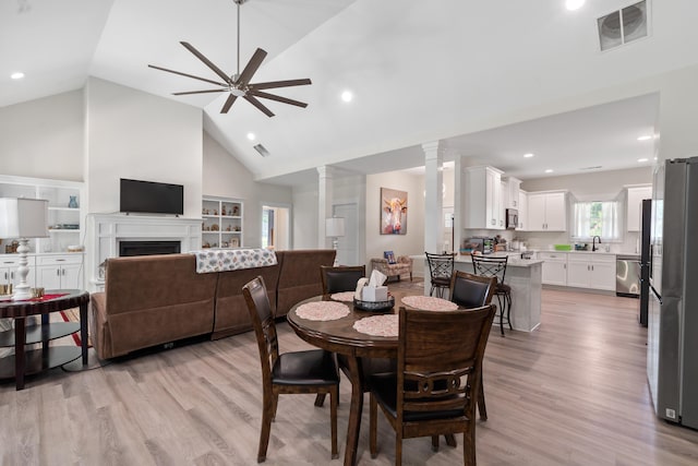 165 Hunters Chase Ct, Eatonton, GA 31024 - dining area with decorative columns, a ceiling fan, light wood-type flooring, high vaulted ceiling, and recessed lighting