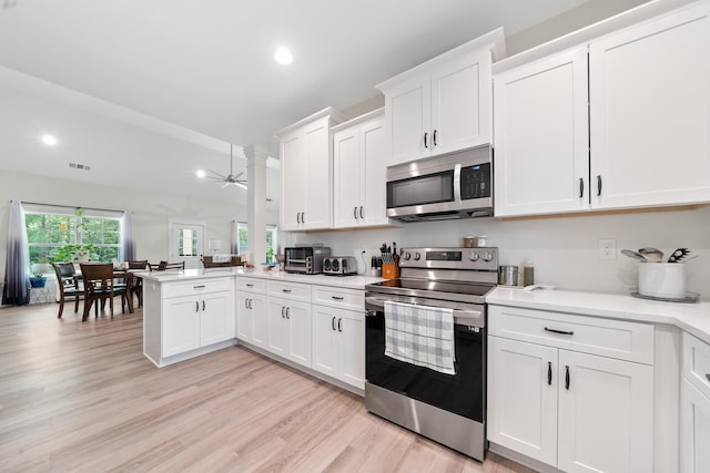 165 Hunters Chase Ct, Eatonton, GA 31024 - kitchen featuring stainless steel appliances, a peninsula, light countertops, white cabinetry, and recessed lighting