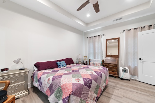 165 Hunters Chase Ct, Eatonton, GA 31024 - bedroom featuring wood finished floors, a tray ceiling, a ceiling fan, and recessed lighting