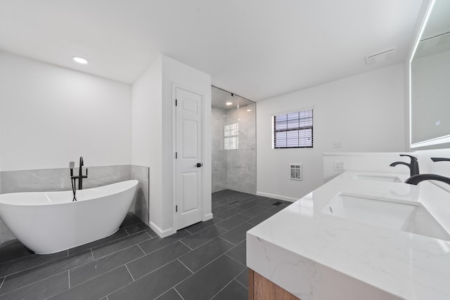32 Lily Pt, Sparta, GA 31087 - bathroom featuring double vanity, a soaking tub, and walk in shower