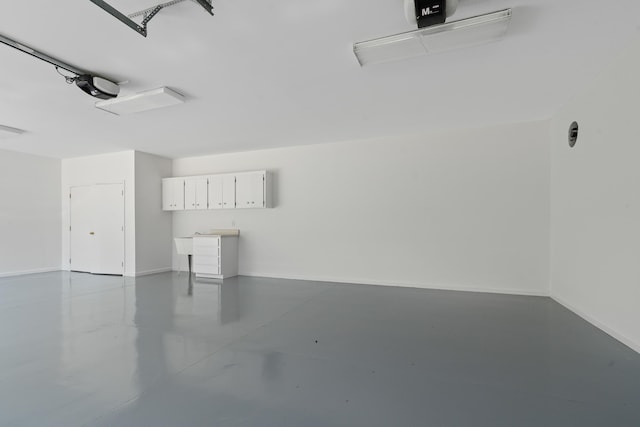 32 Lily Pt, Sparta, GA 31087 - garage featuring a garage door opener and baseboards