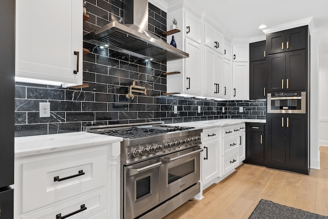 176 Harmony Bay Dr, Eatonton, GA 31024 - kitchen featuring stainless steel appliances, wall chimney range hood, and white cabinets