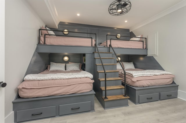 bedroom with ornamental molding and light hardwood / wood-style floors