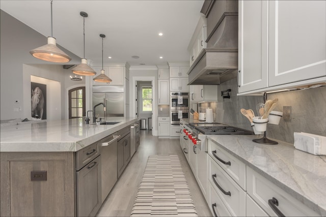 kitchen featuring a large island, hanging light fixtures, white cabinets, and premium range hood