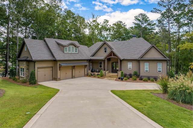 craftsman house with a garage and a front yard