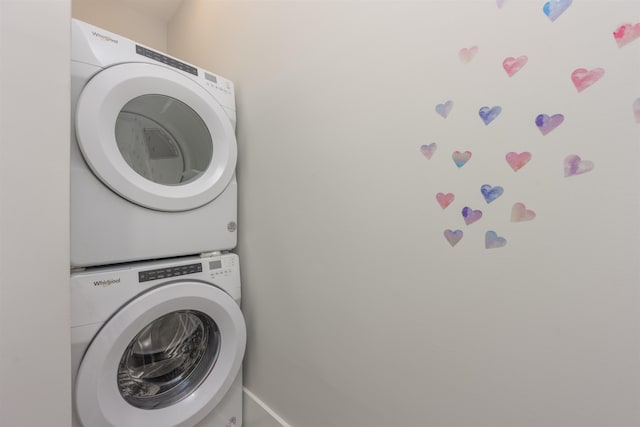 laundry room with stacked washing maching and dryer