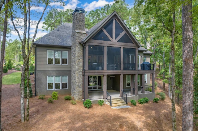 back of house with a sunroom and covered porch