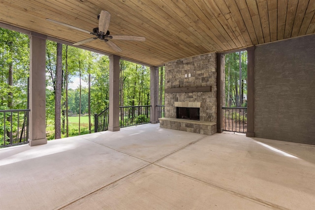 view of patio / terrace with ceiling fan and an outdoor stone fireplace