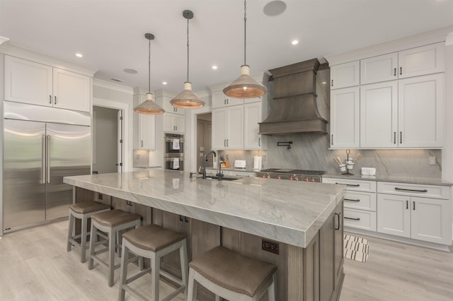 kitchen with premium range hood, a spacious island, pendant lighting, stainless steel appliances, and white cabinets