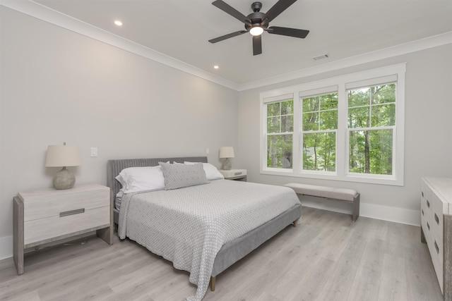 bedroom with ornamental molding, ceiling fan, and light wood-type flooring