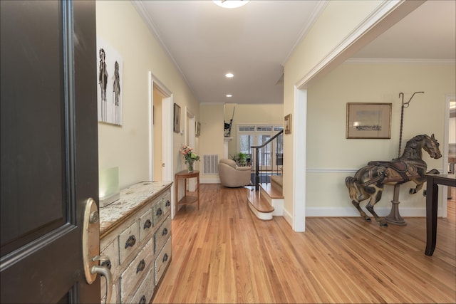 corridor featuring crown molding and light hardwood / wood-style floors