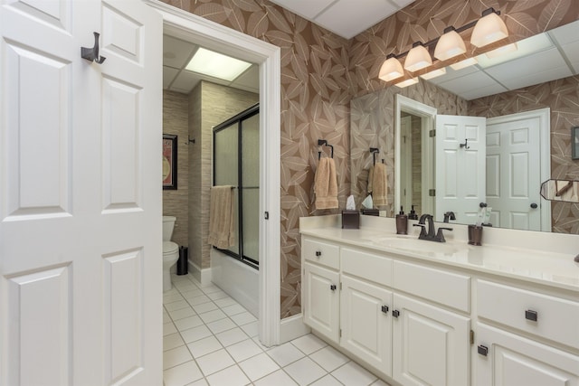 full bathroom with bath / shower combo with glass door, toilet, tile patterned floors, and vanity