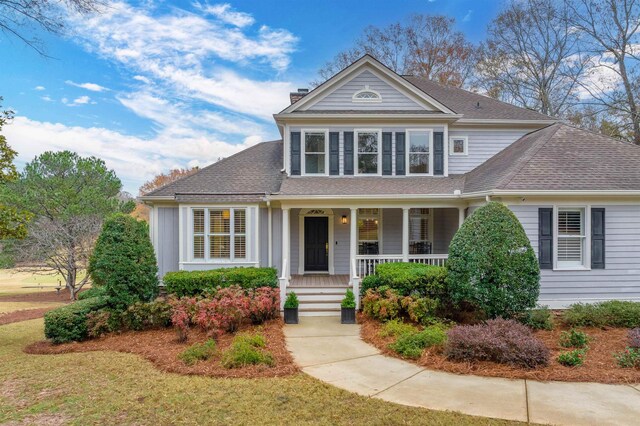 view of front property with a front yard and covered porch