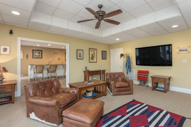 living room featuring carpet flooring, a paneled ceiling, and ceiling fan