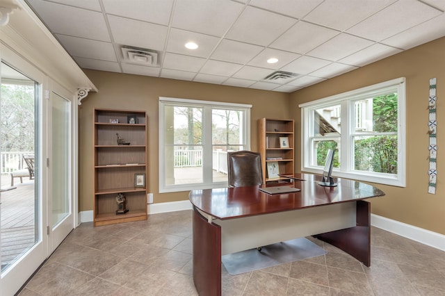 tiled home office with a drop ceiling