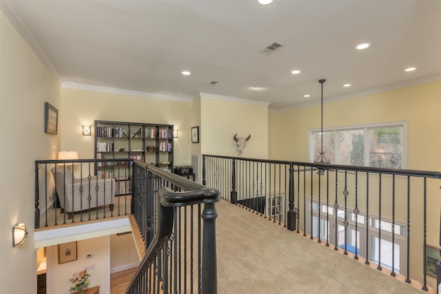 hallway featuring crown molding and carpet flooring