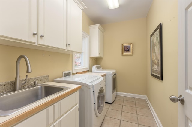 washroom featuring cabinets, sink, light tile patterned floors, and independent washer and dryer