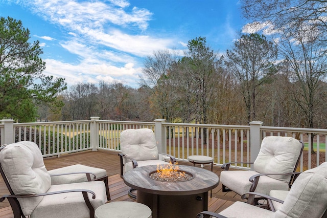 wooden deck with a fire pit