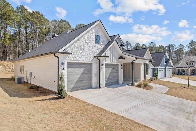 view of property exterior featuring central air condition unit, driveway, a garage, and board and batten siding