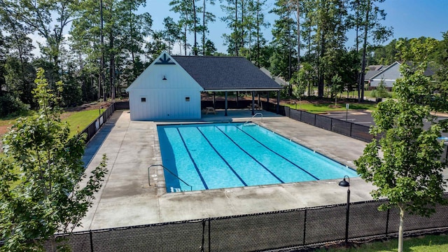 community pool featuring a patio area and fence