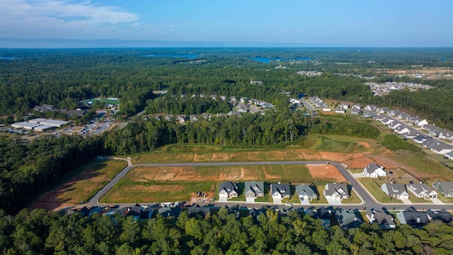 birds eye view of property with a forest view and a residential view