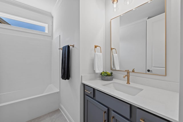 bathroom featuring baseboards, vanity, crown molding, and  shower combination