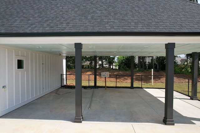 view of patio with a carport and fence