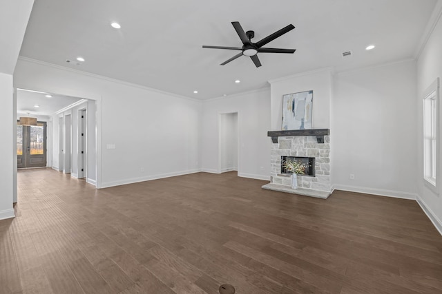 unfurnished living room featuring dark wood-type flooring, a fireplace, crown molding, baseboards, and ceiling fan