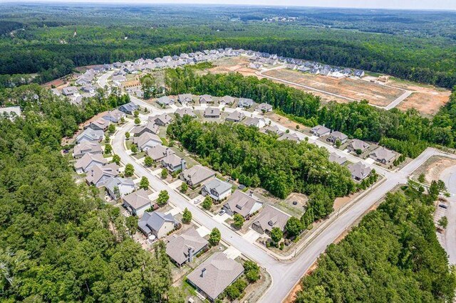 drone / aerial view with a forest view and a residential view