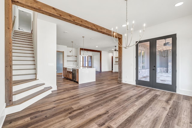 foyer entrance with dark wood-type flooring, sink, beam ceiling, and french doors