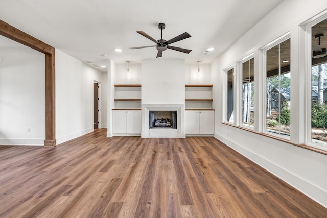 unfurnished living room with wood-type flooring and ceiling fan