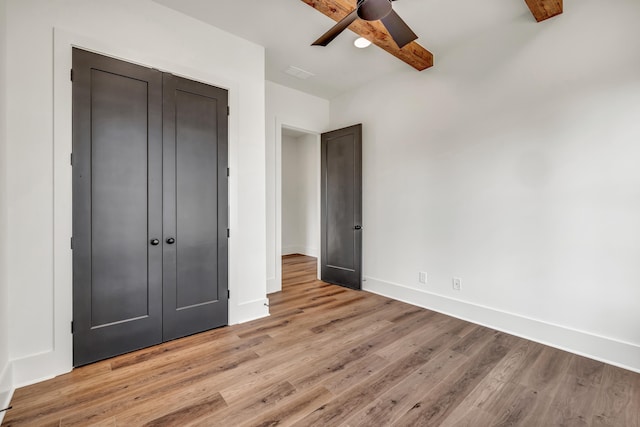 unfurnished bedroom with a closet, ceiling fan, and light hardwood / wood-style flooring