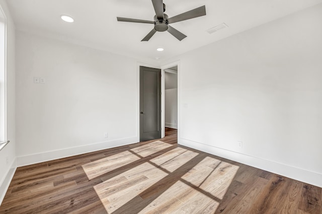 empty room with hardwood / wood-style floors and ceiling fan