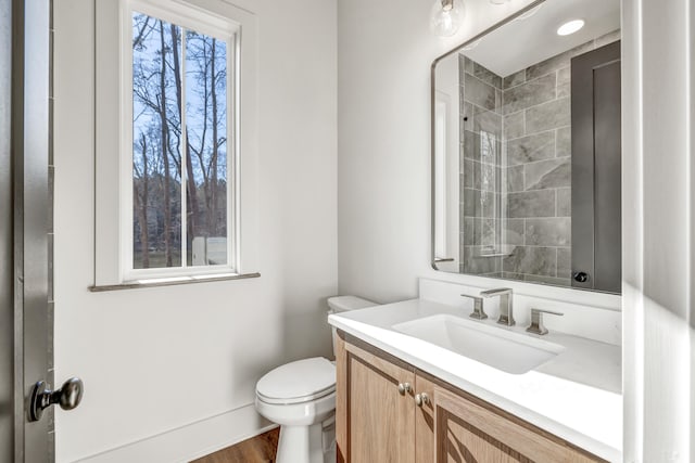 bathroom featuring vanity and toilet