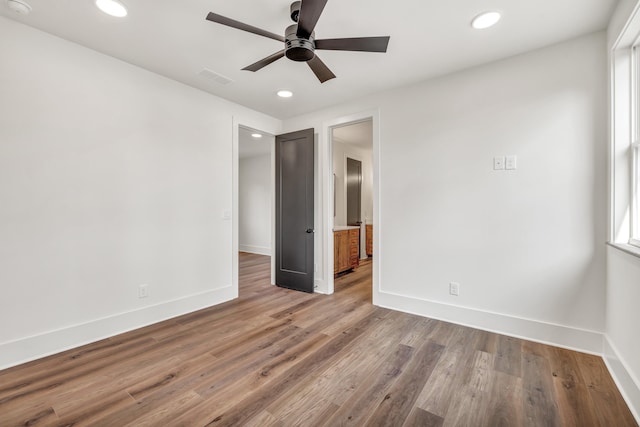 spare room with wood-type flooring and ceiling fan