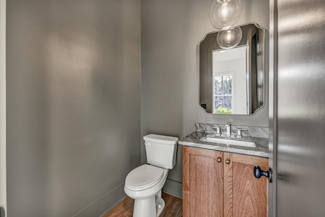 bathroom with vanity, hardwood / wood-style floors, and toilet