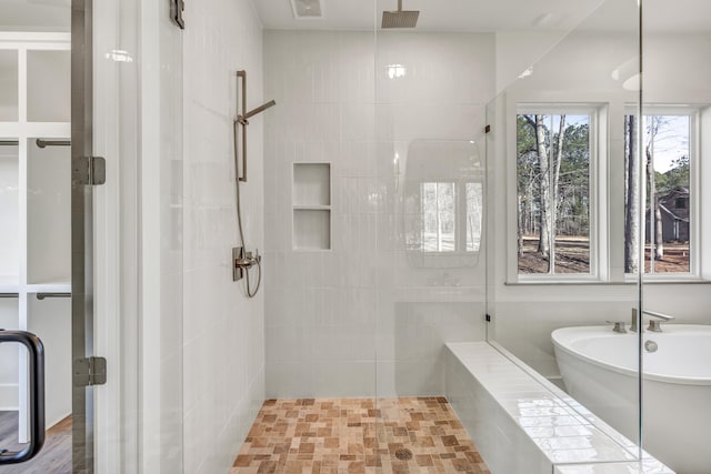 bathroom featuring independent shower and bath