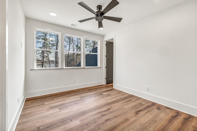 spare room featuring ceiling fan and light wood-type flooring