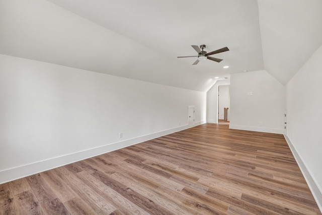 additional living space with lofted ceiling, light hardwood / wood-style flooring, and ceiling fan