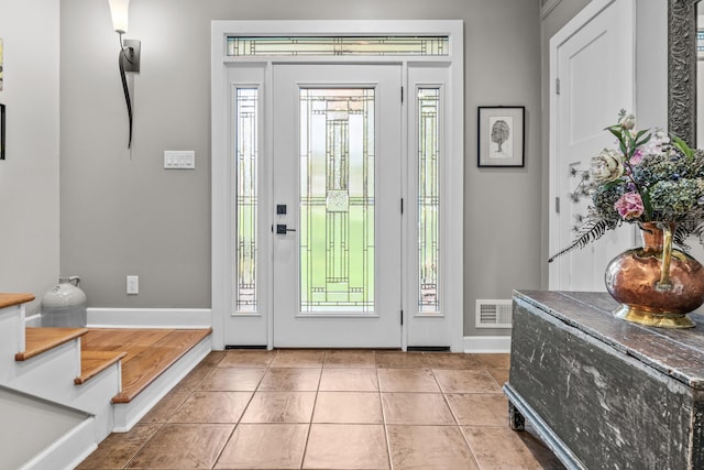 entrance foyer featuring tile patterned floors, baseboards, and visible vents