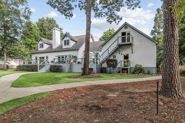 view of front of property featuring a chimney and a front lawn