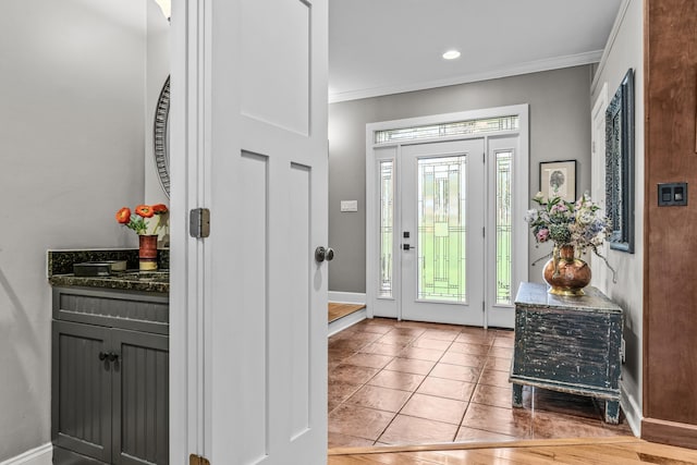 foyer entrance featuring light tile patterned floors, baseboards, ornamental molding, and recessed lighting