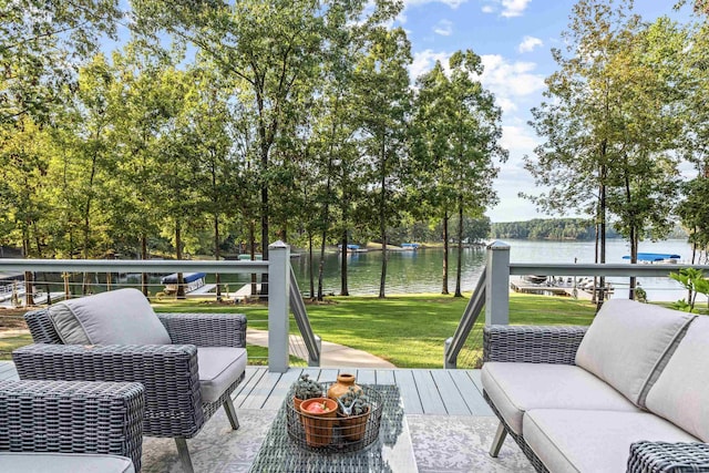 wooden terrace with outdoor lounge area, a yard, and a water view