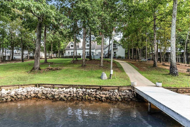 dock area featuring a water view and a lawn