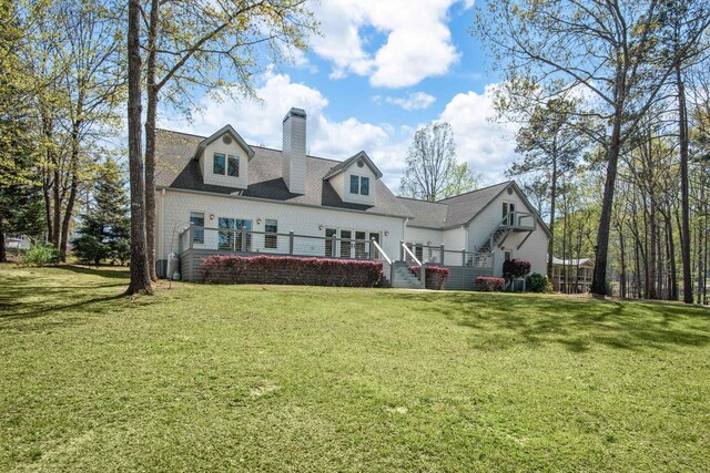 cape cod house featuring a garage and a lawn