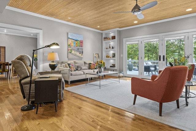 living room with ornamental molding, ceiling fan, wood ceiling, and light hardwood / wood-style floors