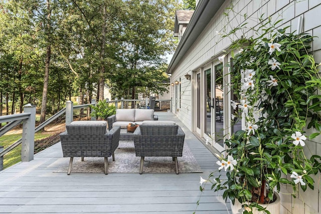 wooden terrace with an outdoor living space