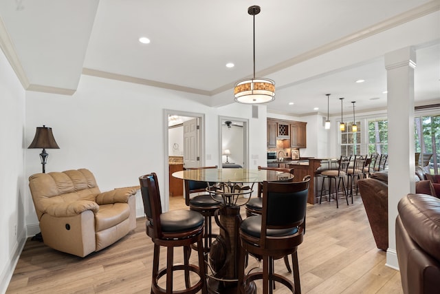 1191 Linger Longer Dr, Greensboro, GA 30642 - dining room featuring light wood finished floors, ceiling fan, recessed lighting, crown molding, and ornate columns