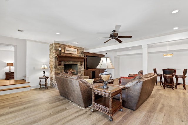 1191 Linger Longer Dr, Greensboro, GA 30642 - living room featuring light wood-style floors, a stone fireplace, a ceiling fan, recessed lighting, and crown molding